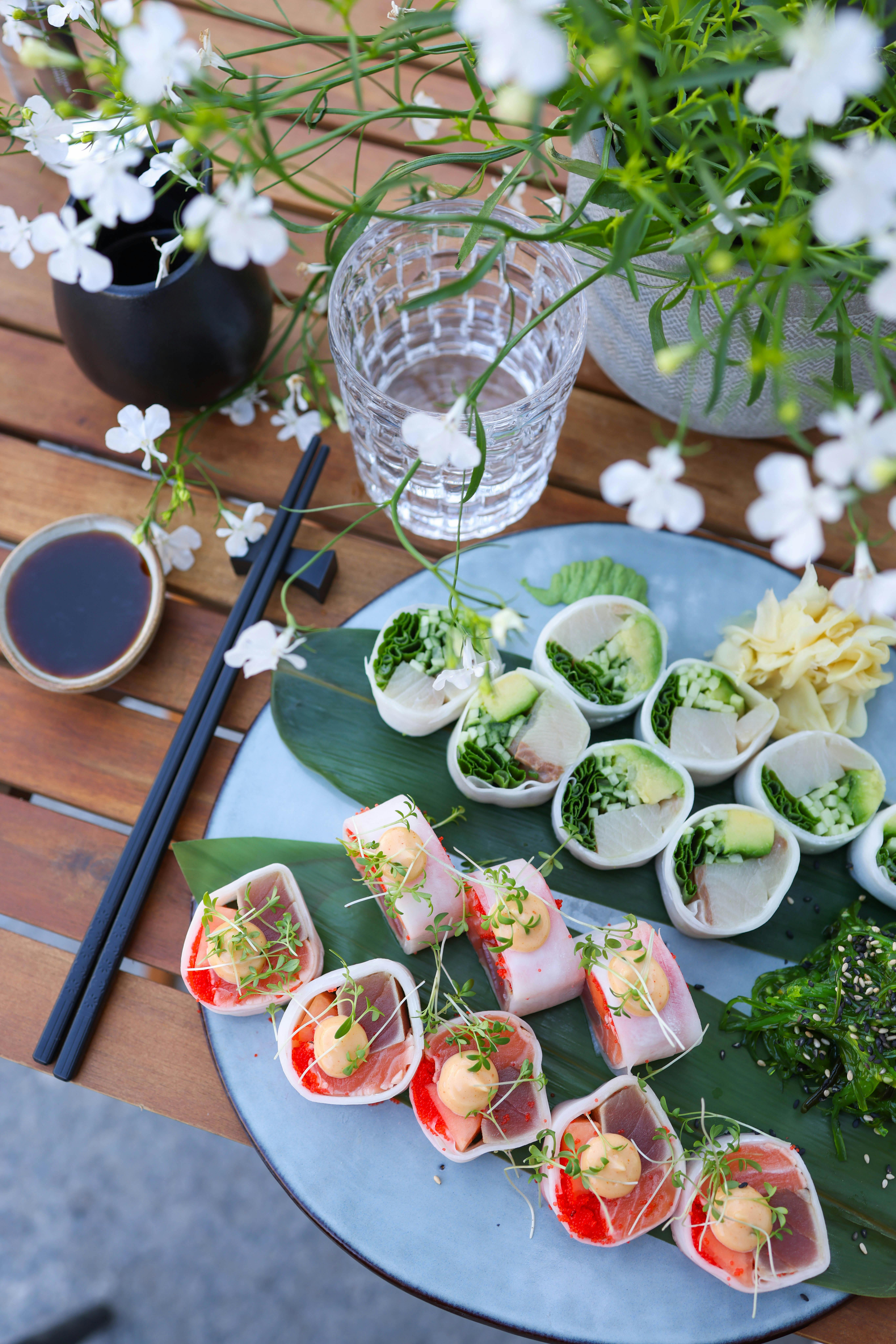 Vibrant sushi platter with green and white decor, perfect for fine dining.