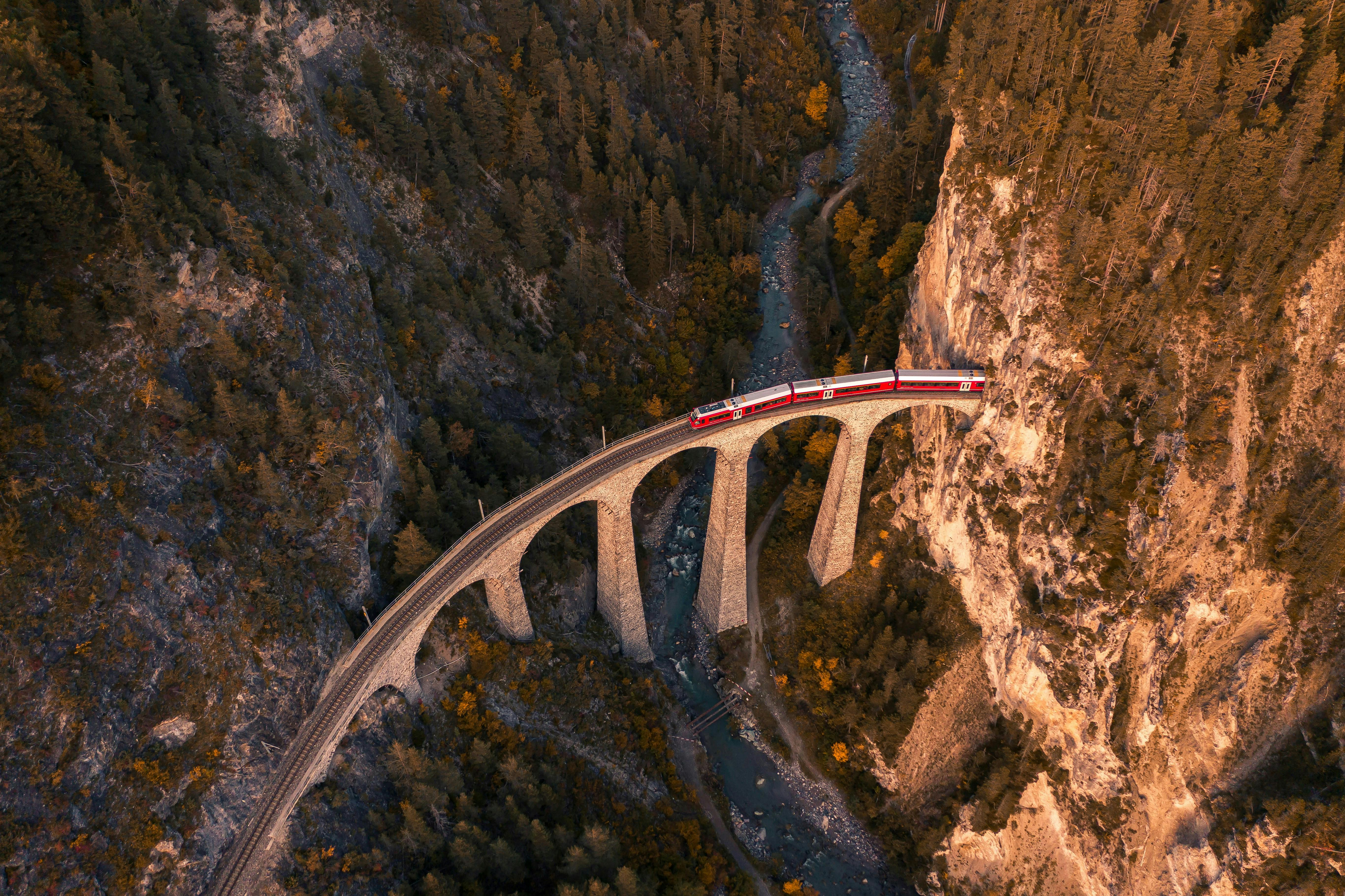 Drone shot of a train crossing the iconic Landwasser Viaduct in Switzerland.