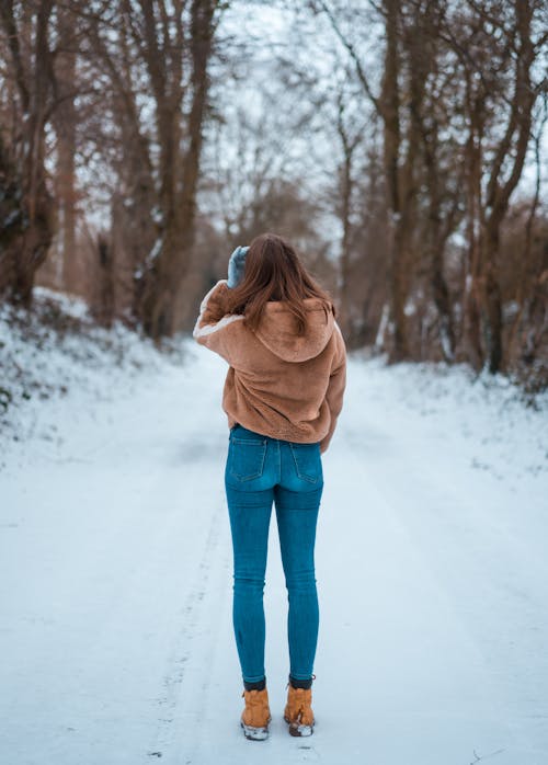 Woman Standing on Snow Covered Ground