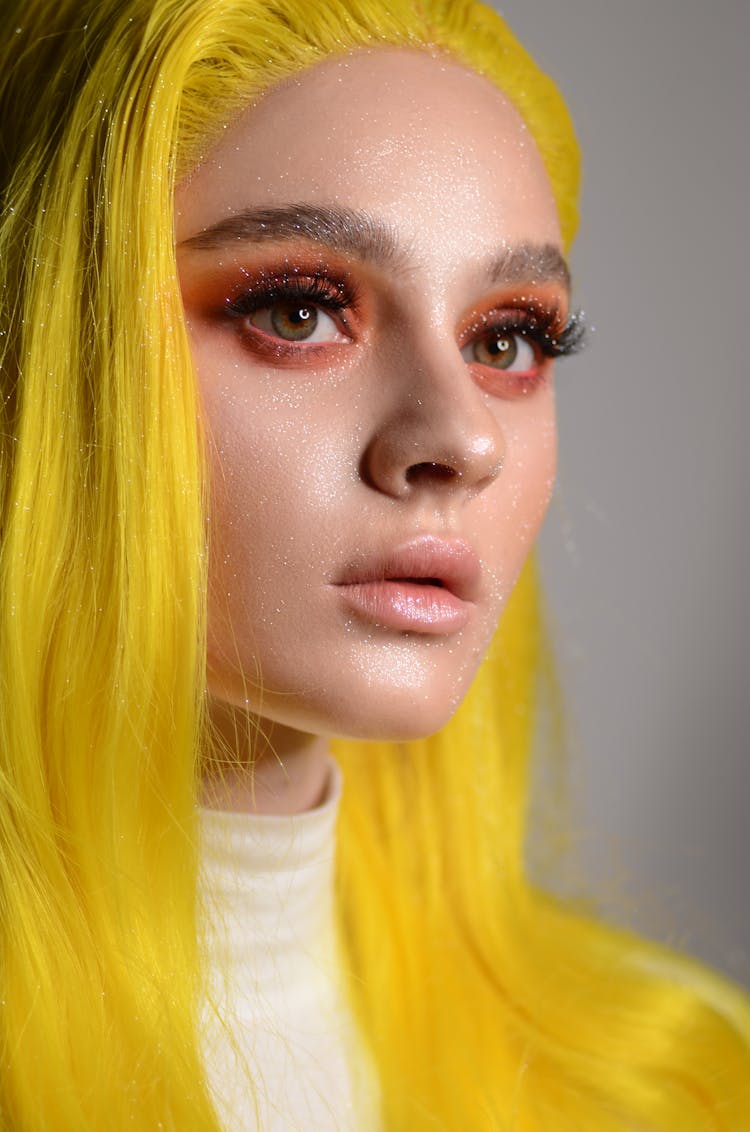Portrait Photo Of Woman With Yellow Hair And Glitter On Her Face Posing
