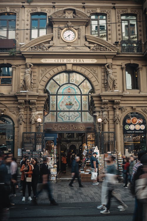 A group of people walking in front of a building