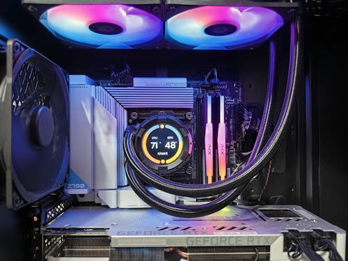 A computer case with a fan and a rainbow colored light