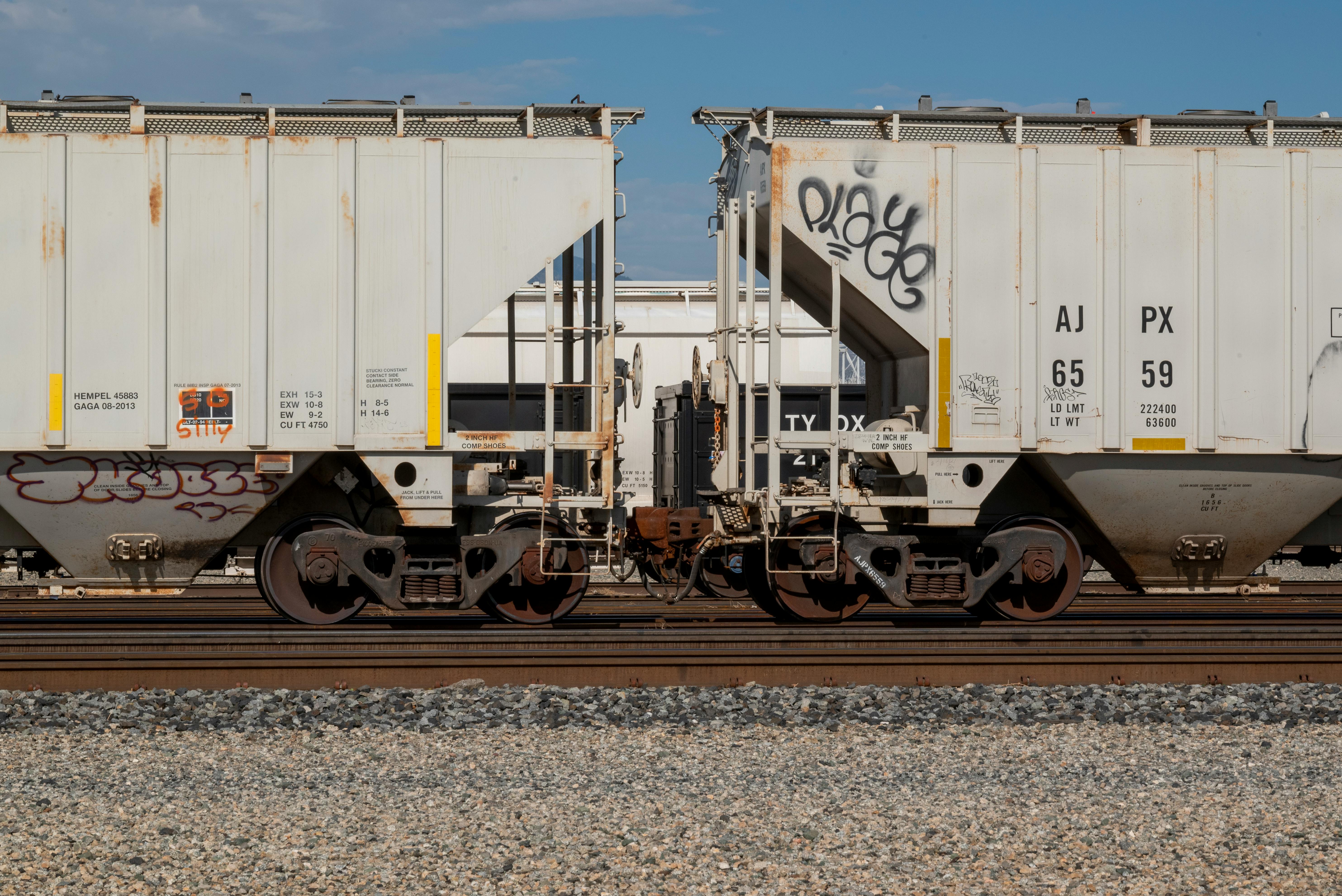 Close-up of cargo train with graffiti on tracks in Mojave, California.