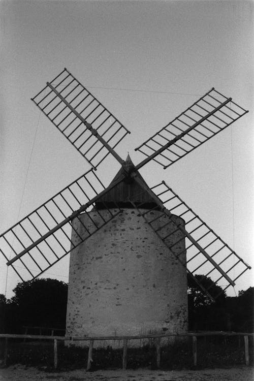 A black and white photo of a windmill