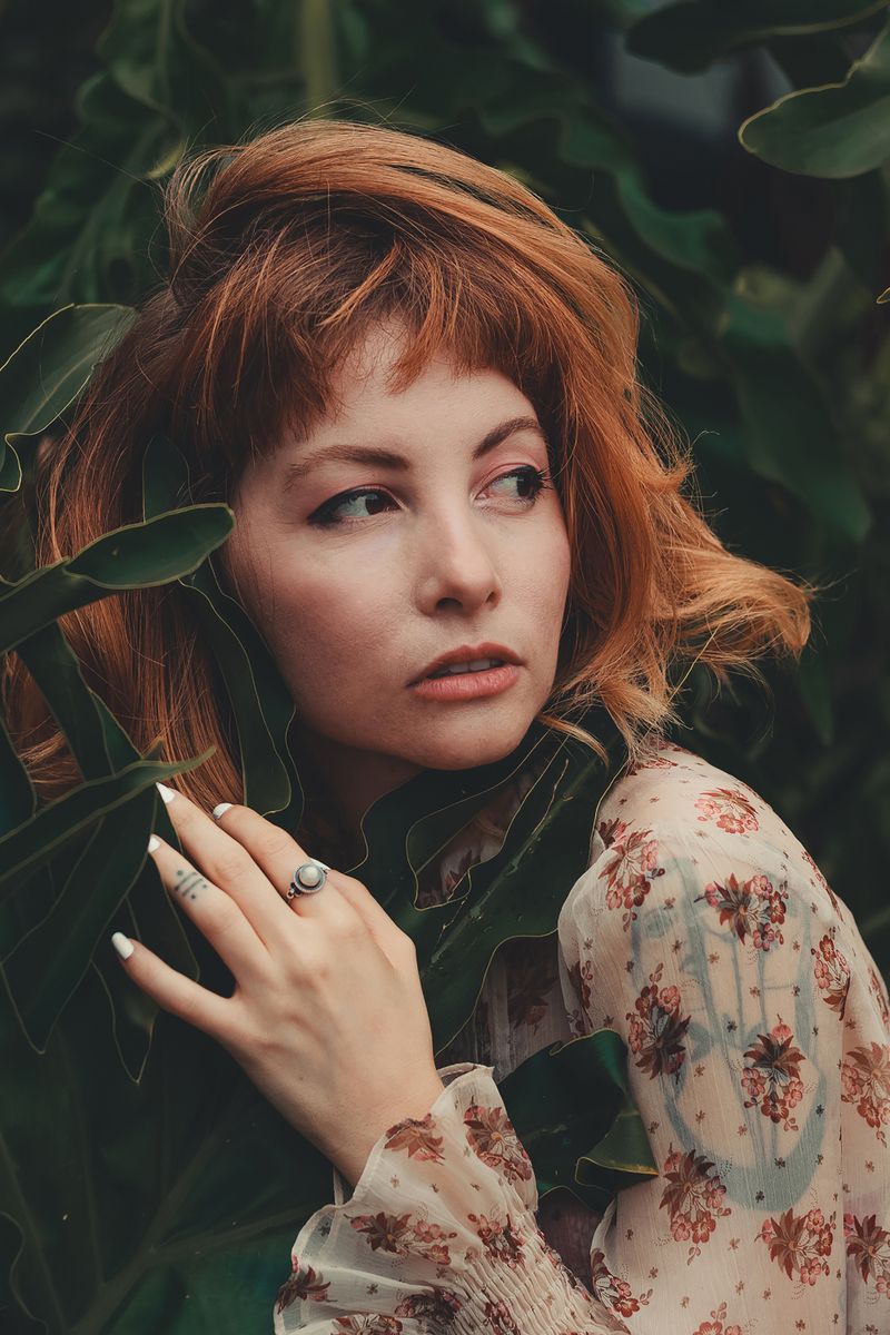 Close portrait framed by leaves — Gabi Guerino on Pexels