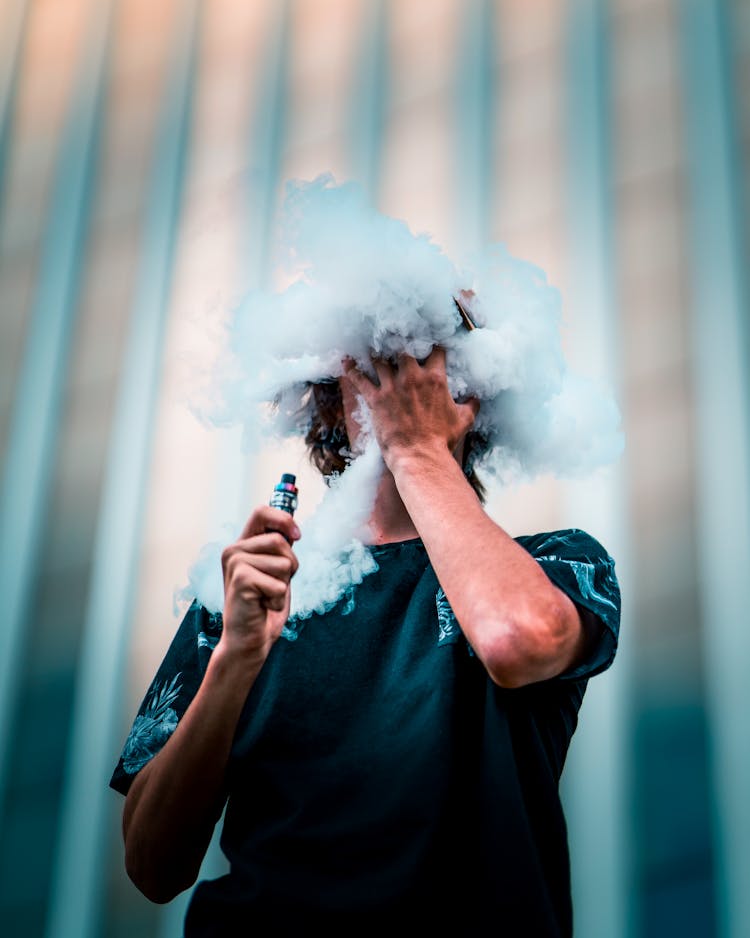 Selective Focus Photography Of Man Doing Vape Trick