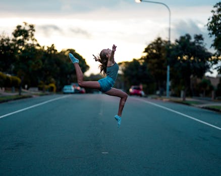 黄昏时分，一名年轻女子在安静的城市街道上跃起的动态镜头
