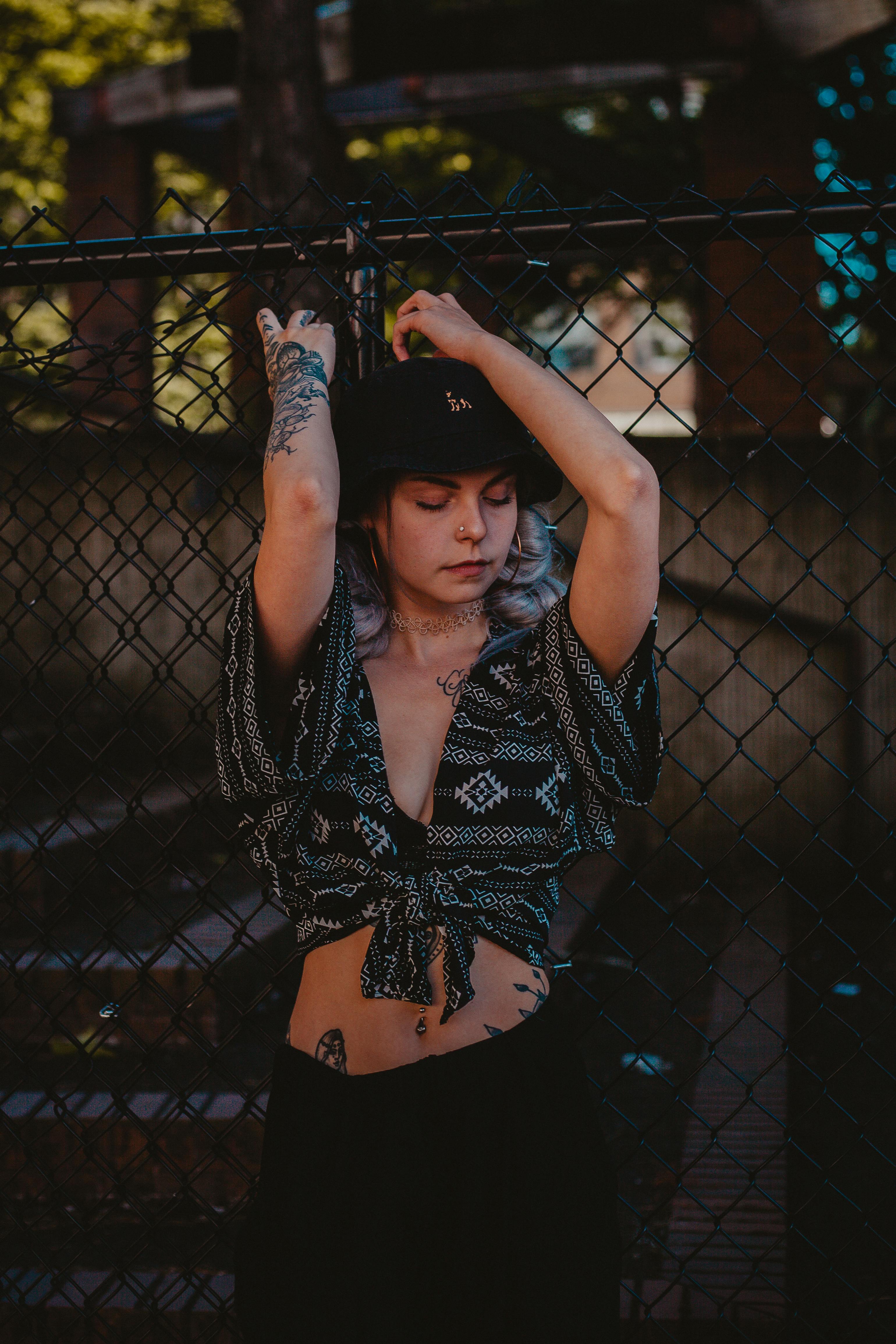 woman wearing black v neck crop top holding the gate