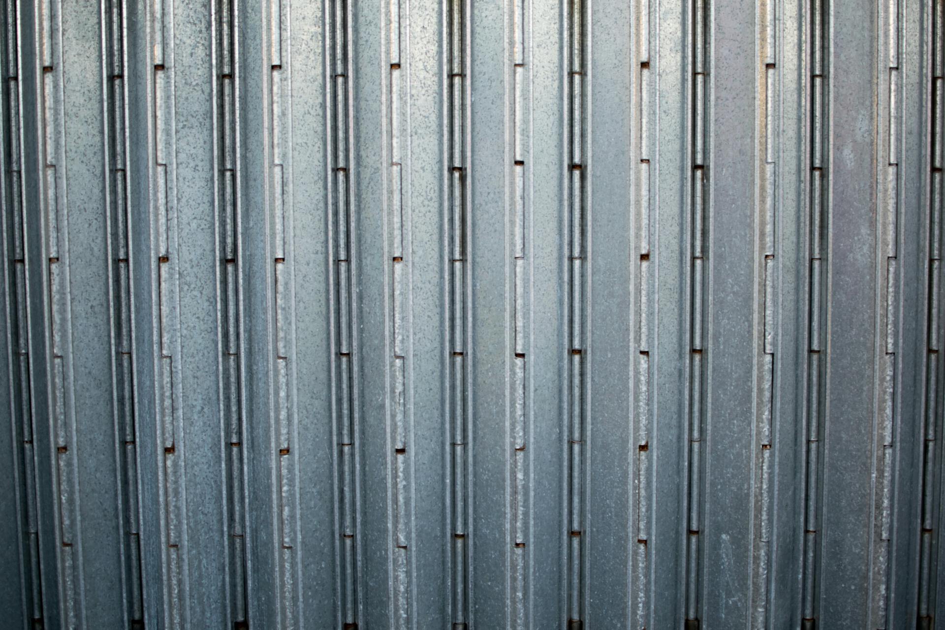 Close-up of a grey corrugated metal surface showcasing its uniform pattern and sturdy construction.