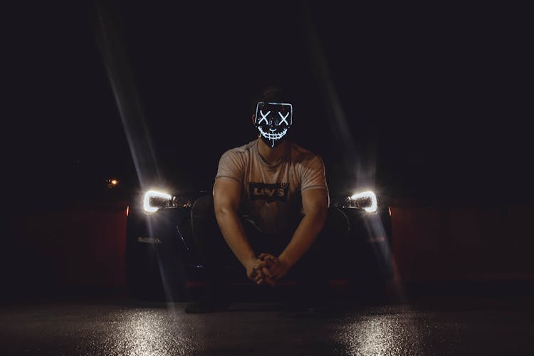 Photo Of Man Wearing Mask In Front Of Car