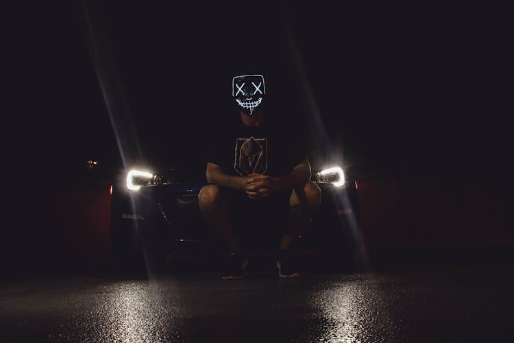 Photo Of Person Wearing Mask While In Front Of Vehicle