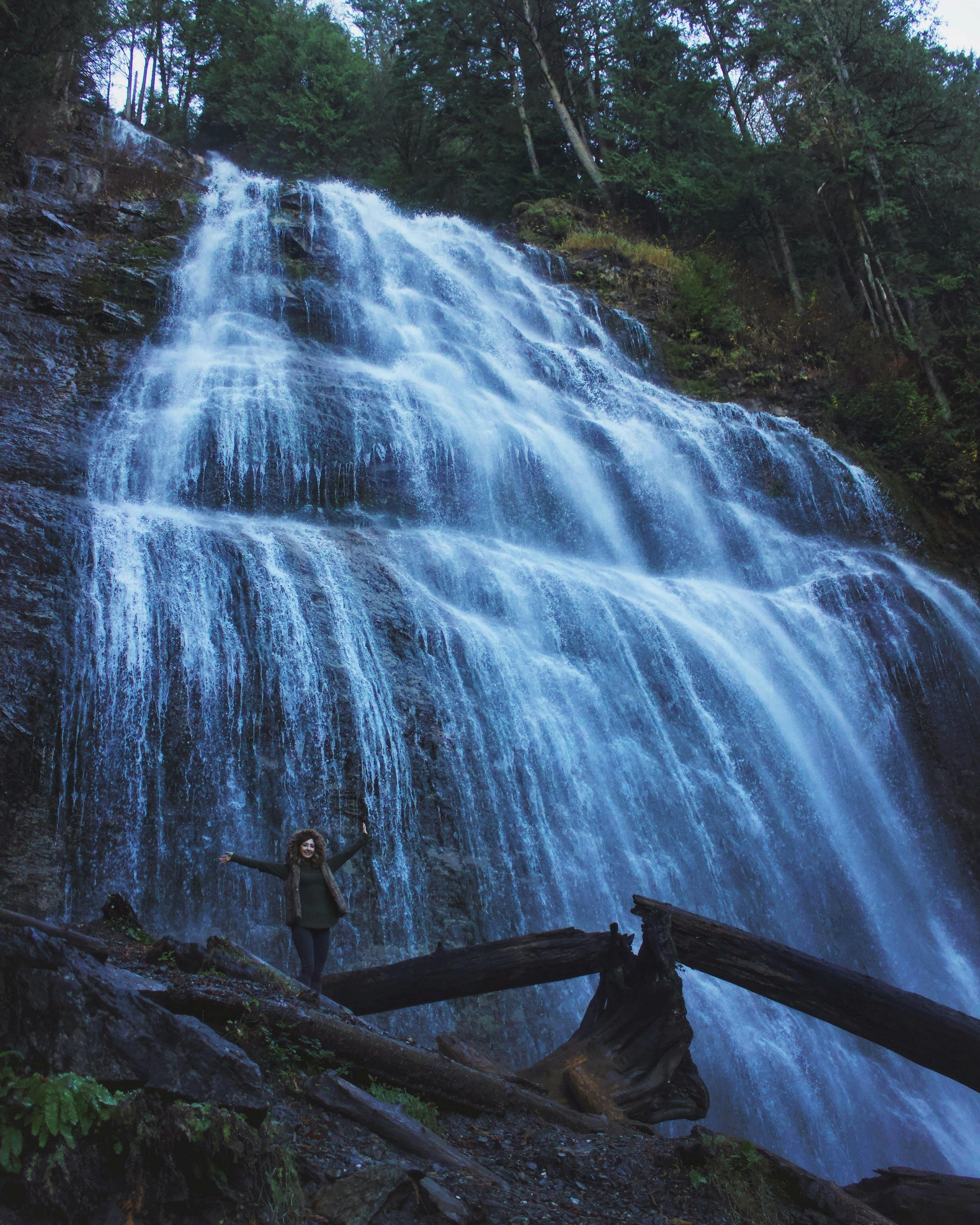 Woman Standing Under Waterfalls · Free Stock Photo