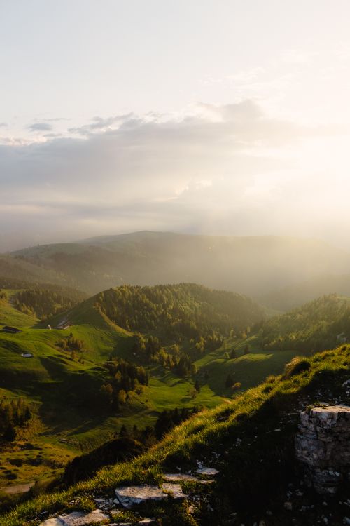 Free Breathtaking view of lush green hills under a golden sunset in Crespano del Grappa, Italy. Stock Photo