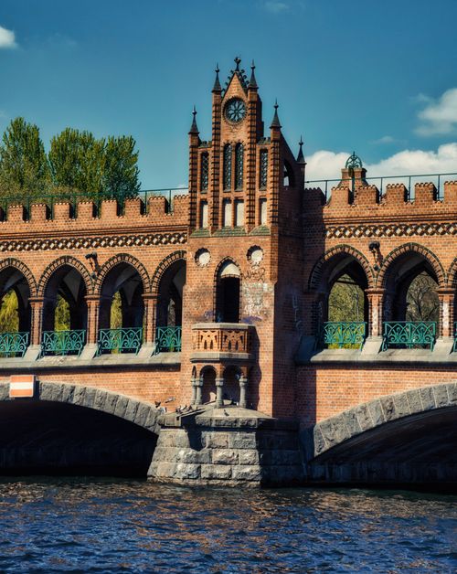 Free Scenic view of Oberbaum Bridge in Berlin with intricate gothic architecture over the Spree River. Stock Photo