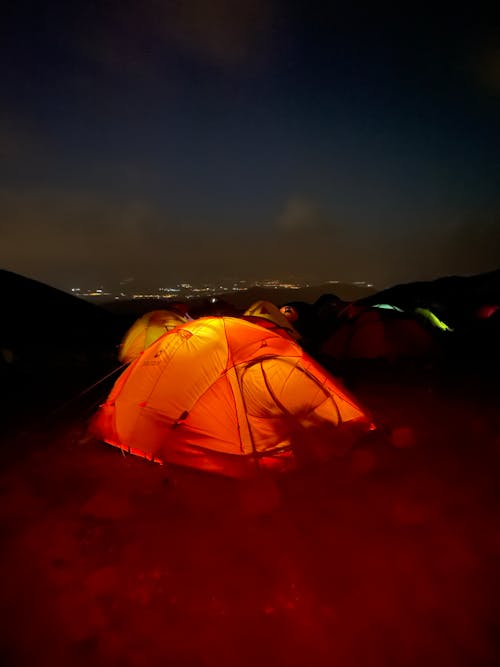 A tent is lit up at night with a red light