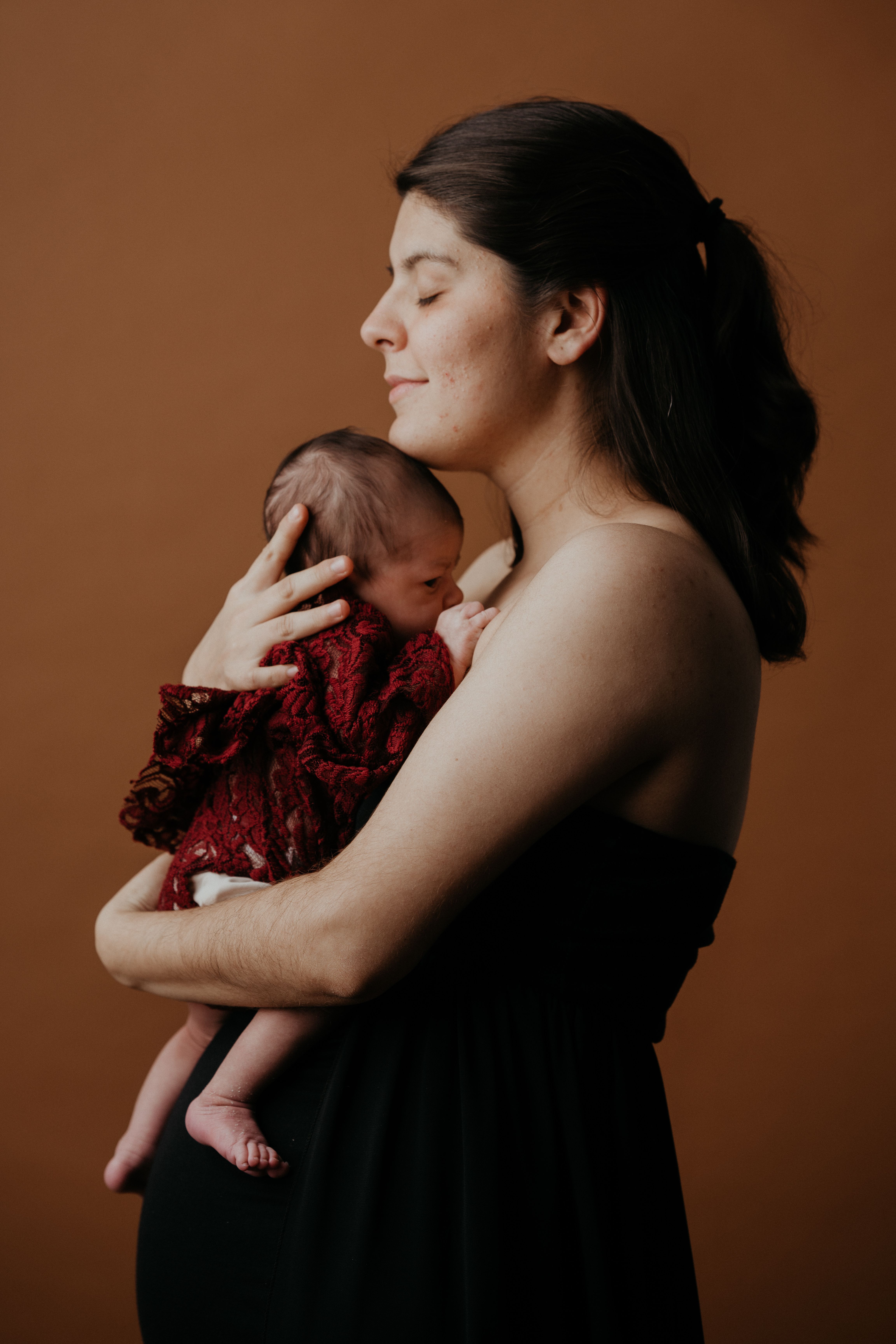 Studio Shot of a Woman Holding Her Newborn Baby · Free Stock Photo