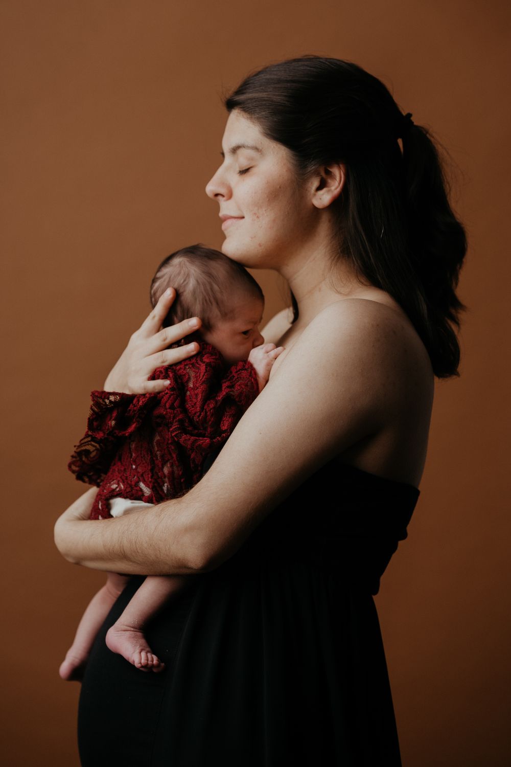 Studio Shot Of A Woman Holding Her Newborn Baby Free Stock Photo studio-shot-of-a-woman-holding-her-newborn-baby-free-stock-photo