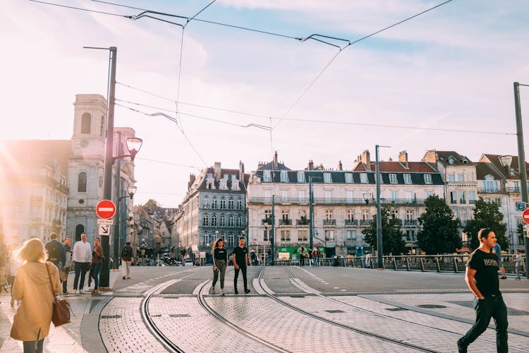 Photo Of People Walking Near Tram Lines