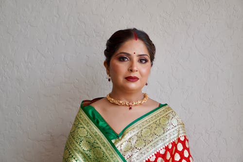 A woman in a red and green sari