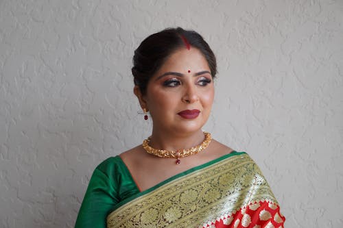 A woman in a green and red sari