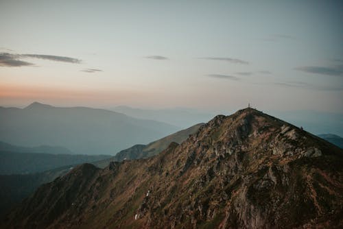 Mountain peak in cloudy evening sky