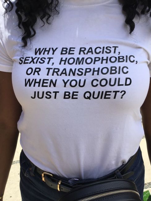 White t-shirt with powerful anti-discrimination message, promoting inclusivity and respect.