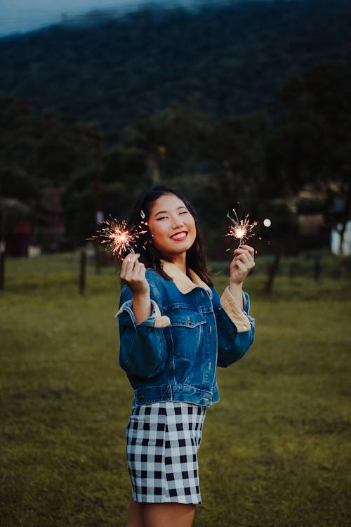 Photo of a Woman Holding Sparklers