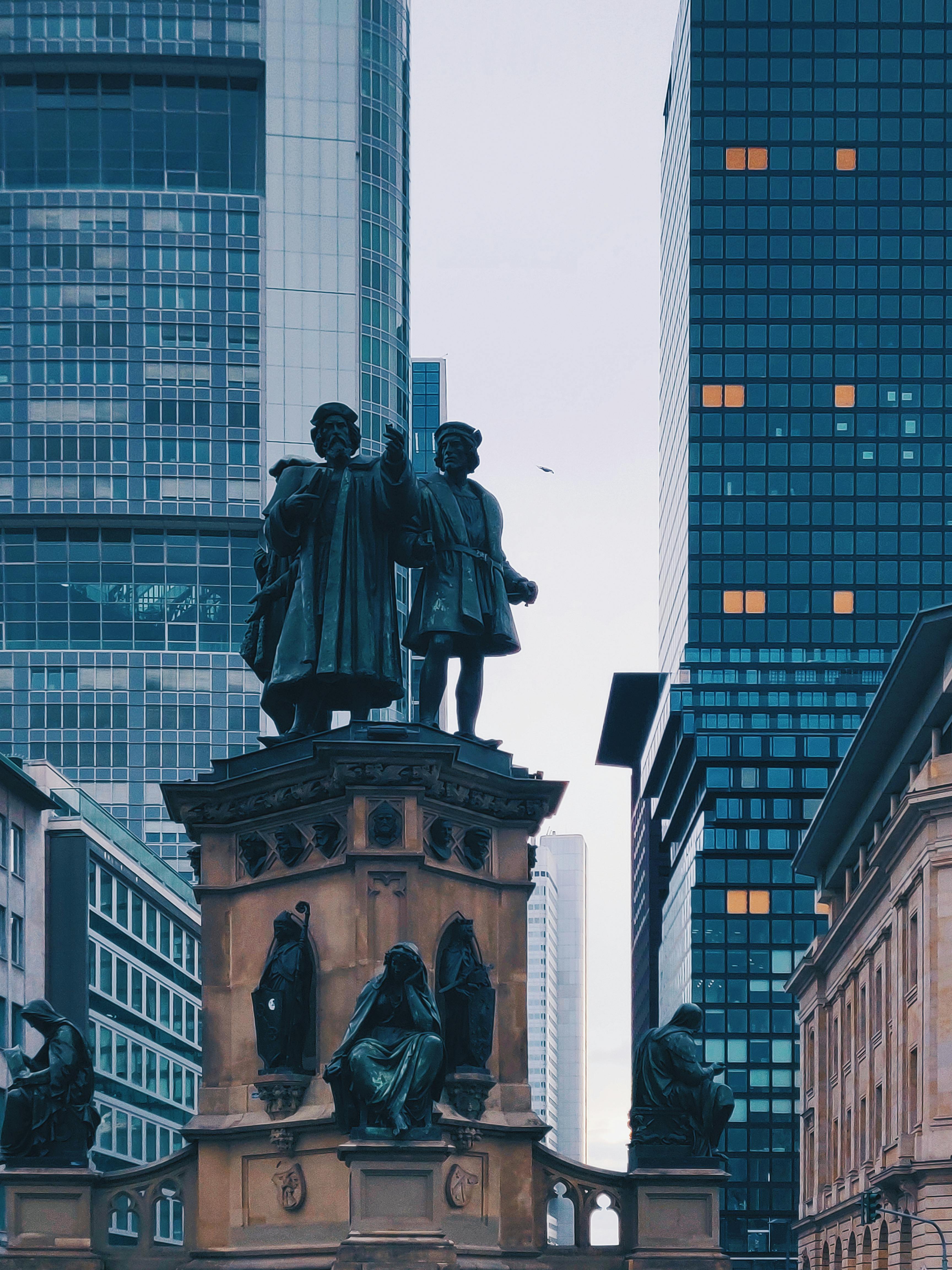 Photo of Monument Near Buildings \u00b7 Free Stock Photo