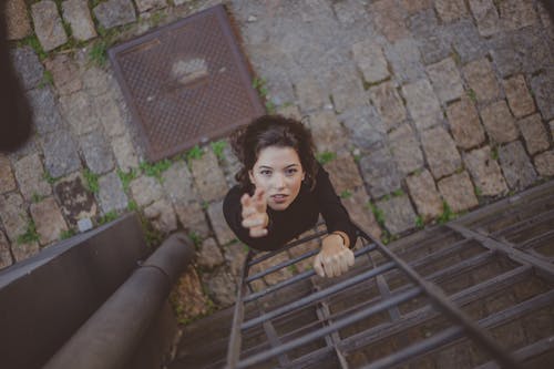 Free Photo of Woman Climbing on Ladder Stock Photo