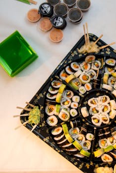 A vibrant sushi platter featuring various rolls with accompanying chopsticks, perfect for Japanese cuisine lovers.