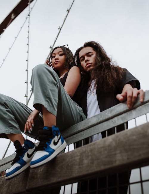 Man and Woman Posing Near A Rail