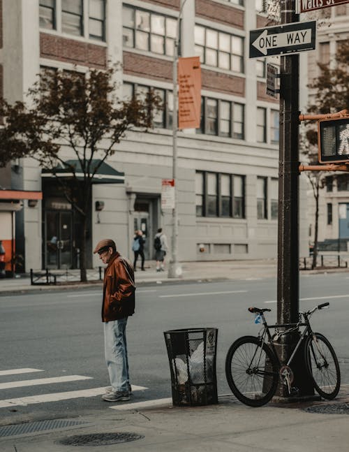 Photo of Man Standing in Pedestrian Lane