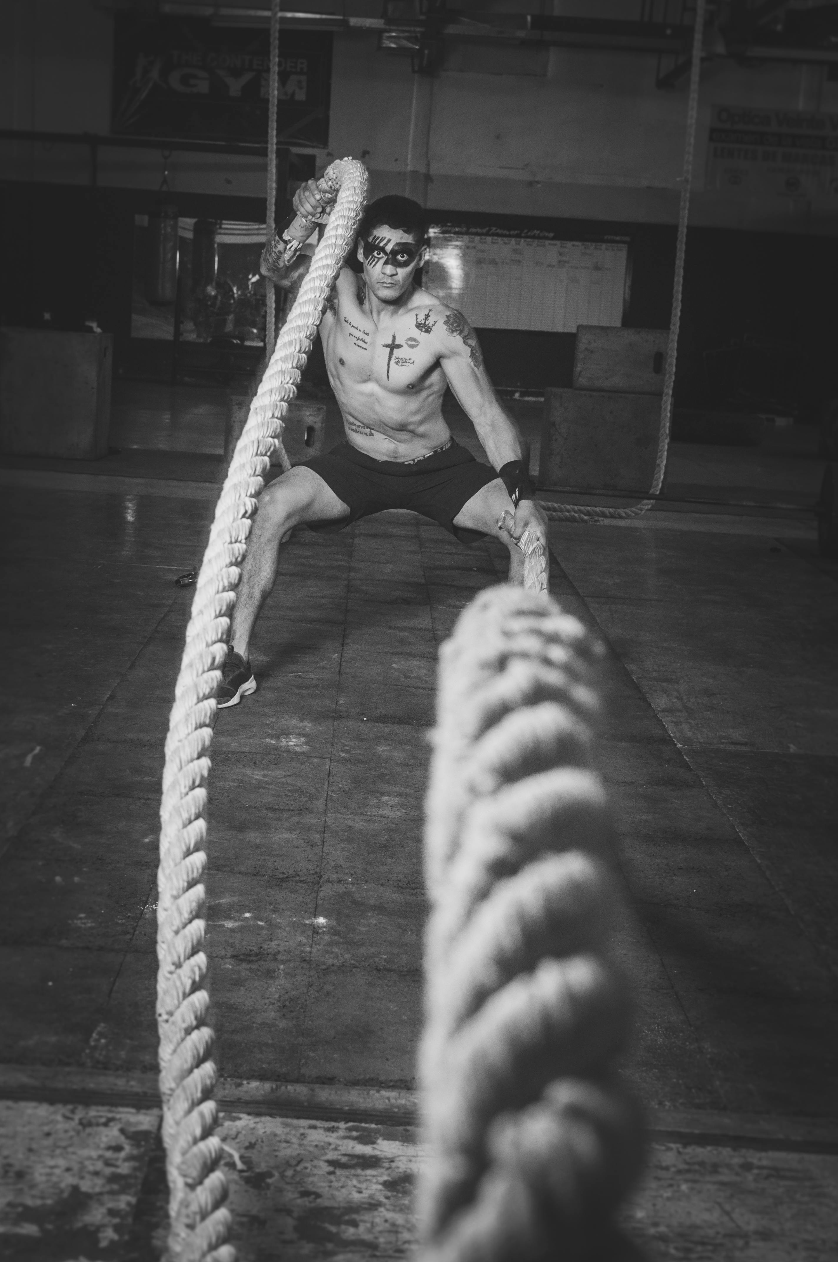 grayscale photography of man holding ropes