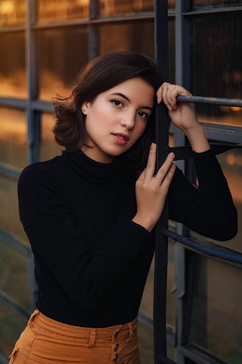 Woman Leaning on Metal Frame