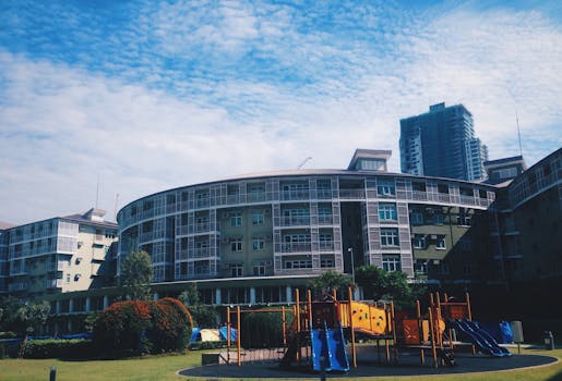 Contemporary apartment building with adjacent playground in urban setting.