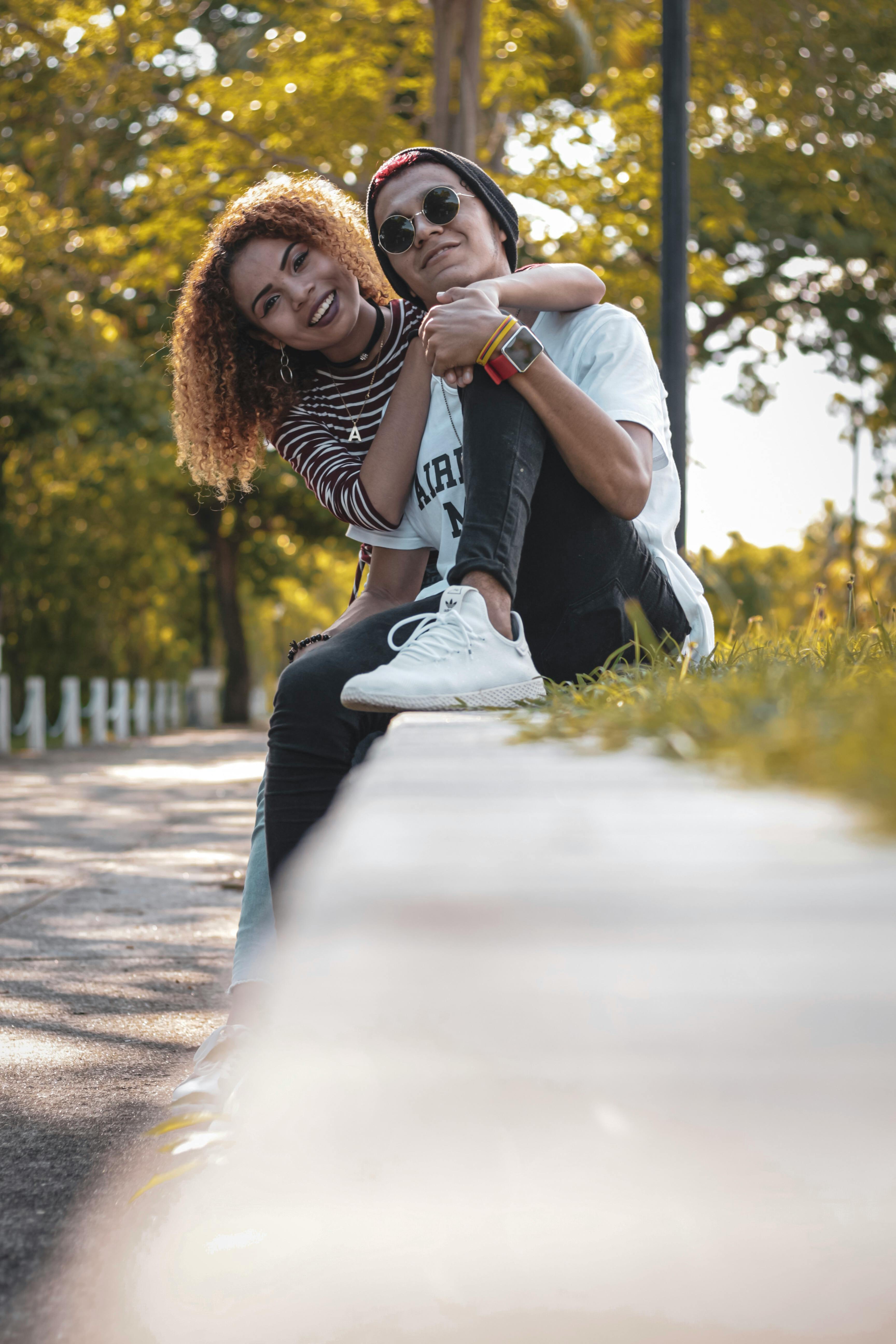 photo of couple sitting outdoors