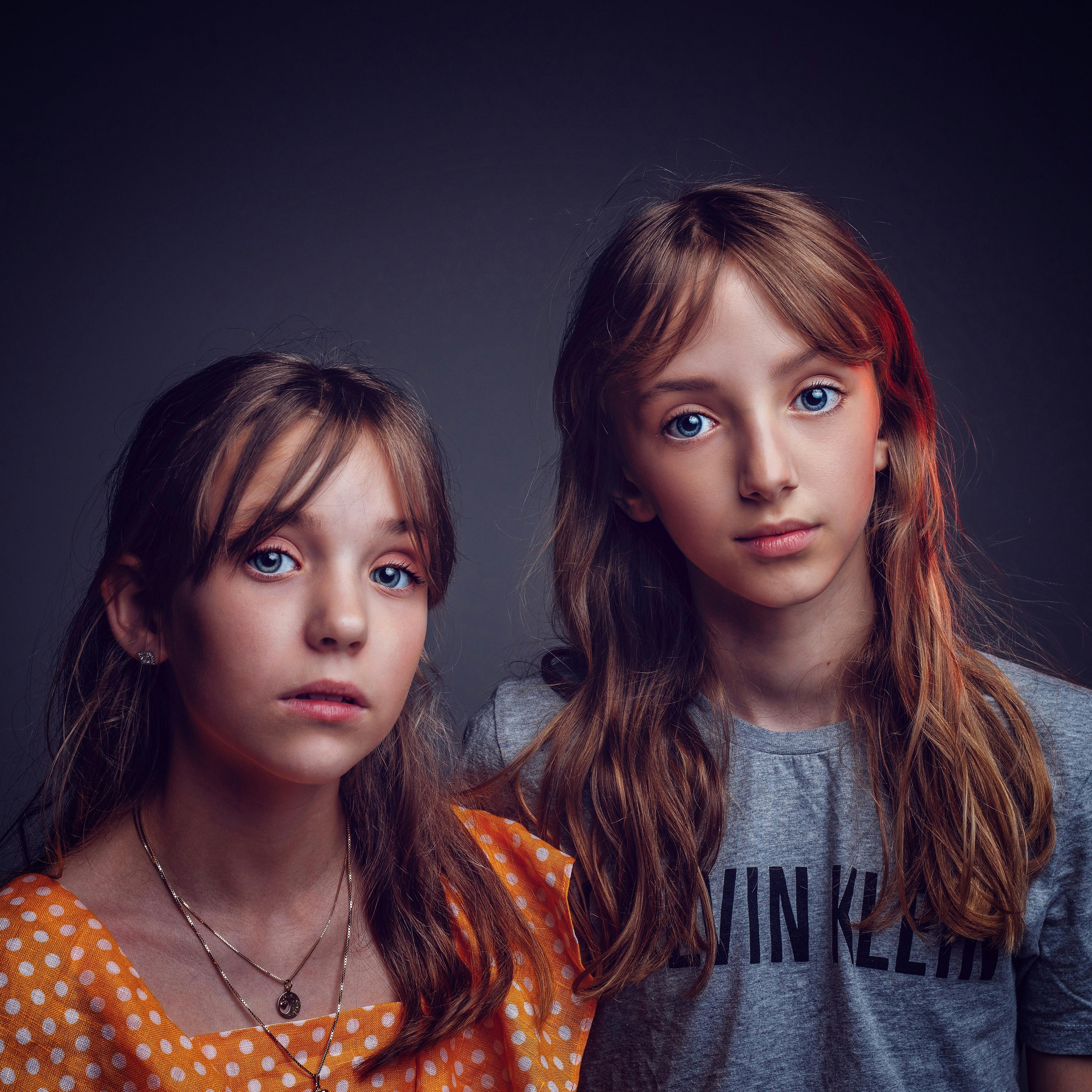 twin girls standing side by side