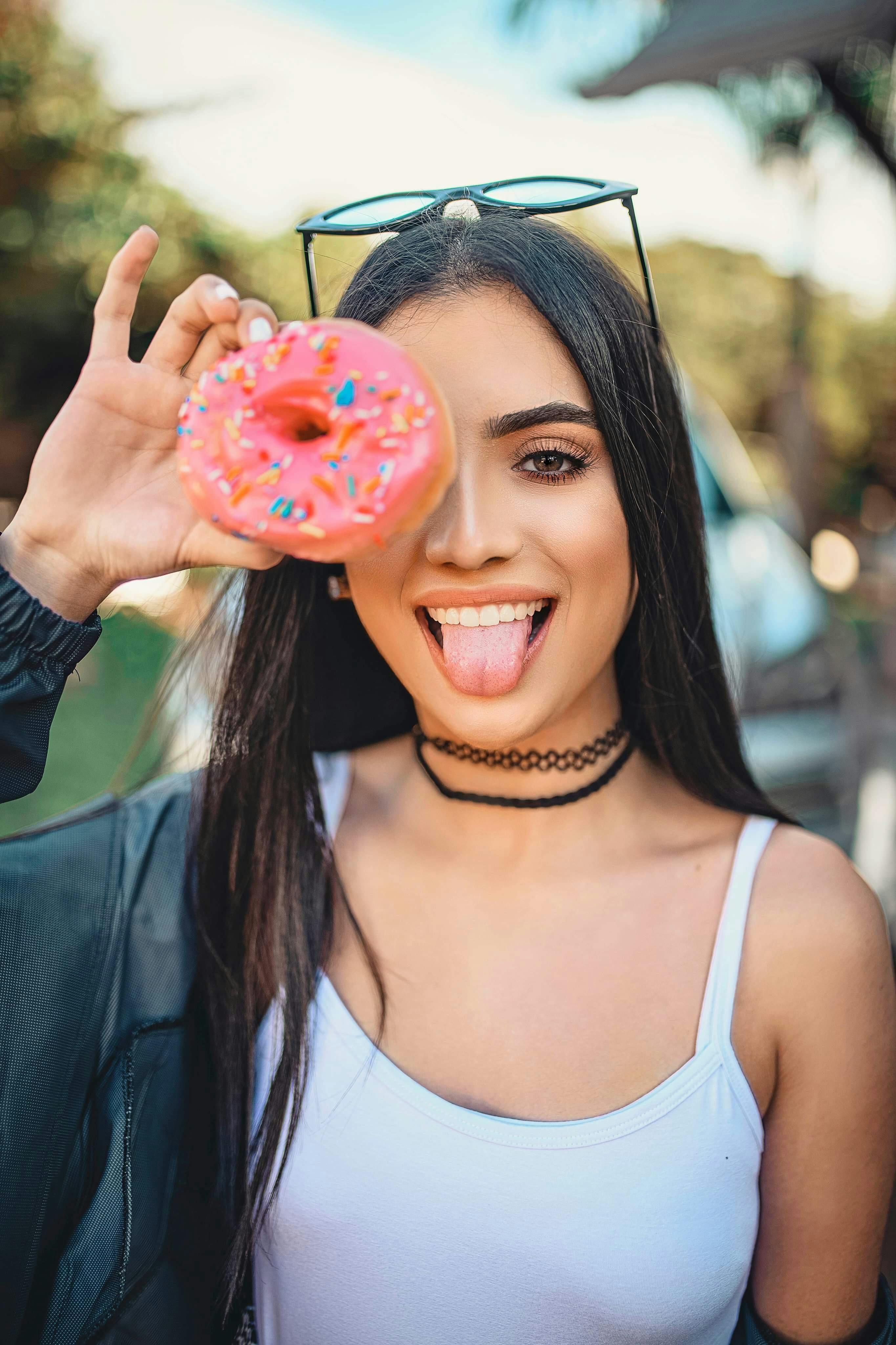 Woman In White Spaghetti Strap Top Holding Doughnut