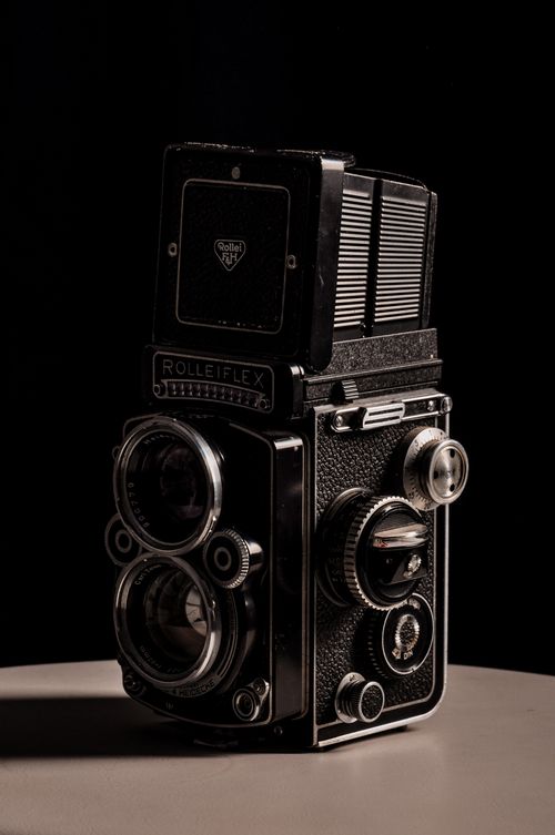 Free Classic Rolleiflex camera on a dark backdrop, highlighting its vintage design and intricate details. Stock Photo