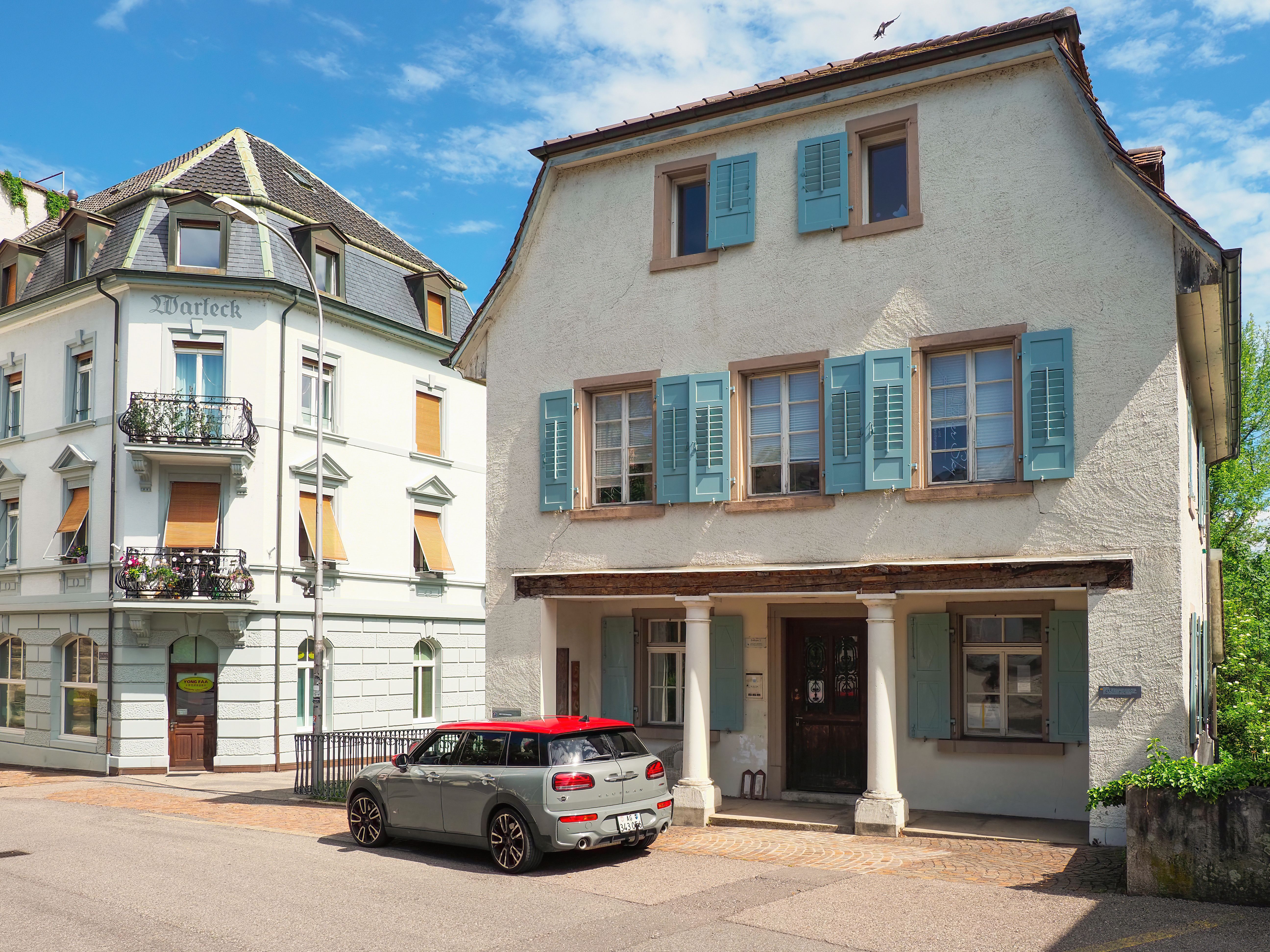 A Car Parked in Front of Houses with Window Shutters · Free Stock Photo