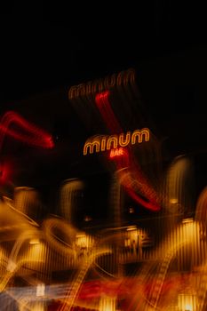 A vibrant, abstract photo of a bar sign captured at night with a long exposure effect.
