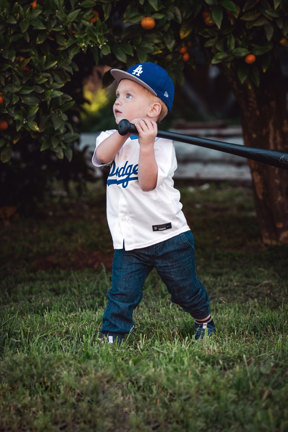 Young child confidently holding a baseball bat