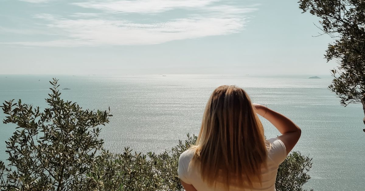 Womanly View Back of a Woman Looking at the Sea from a Coastal Clifftop · Free Stock ...