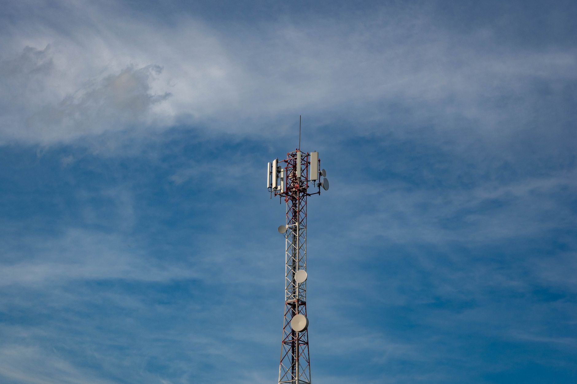 Telecommunications tower in Grubišno Polje against a blue sky, symbolizing modern connectivity.