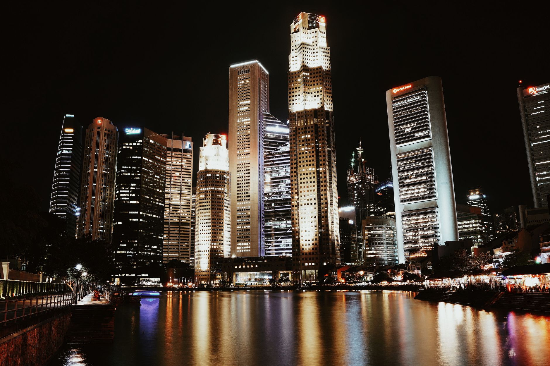 Illuminated skyline reflecting in water, showcasing Singapore's modern architecture. Related image for Market Trends: Key Lessons for Owners and Operators.