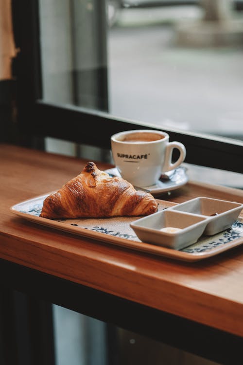 Free Croissant and Coffee on Table Stock Photo