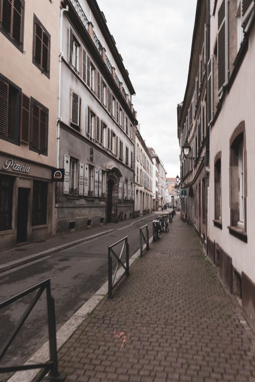 Free A serene street in Strasbourg with vintage architecture and a moody sepia tone. Perfect for urban exploration. Stock Photo