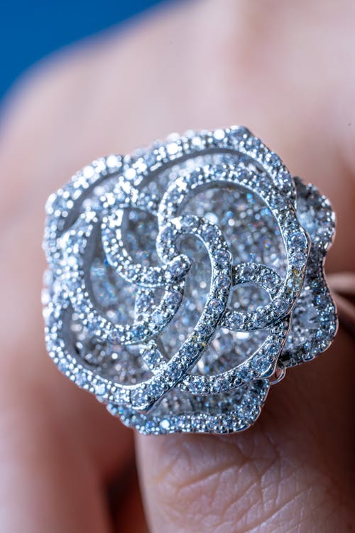 A diamond ring with a rose design on it