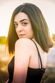 这幅女性肖像画令人惊叹，描绘了一位在户外阳光下摆姿的女性，散发着优雅的气质