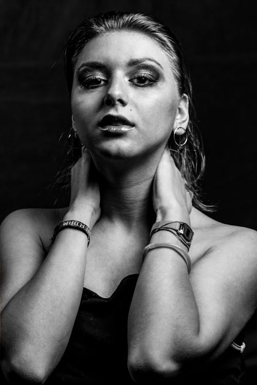 Monochrome Photo of Woman Holding Her Neck